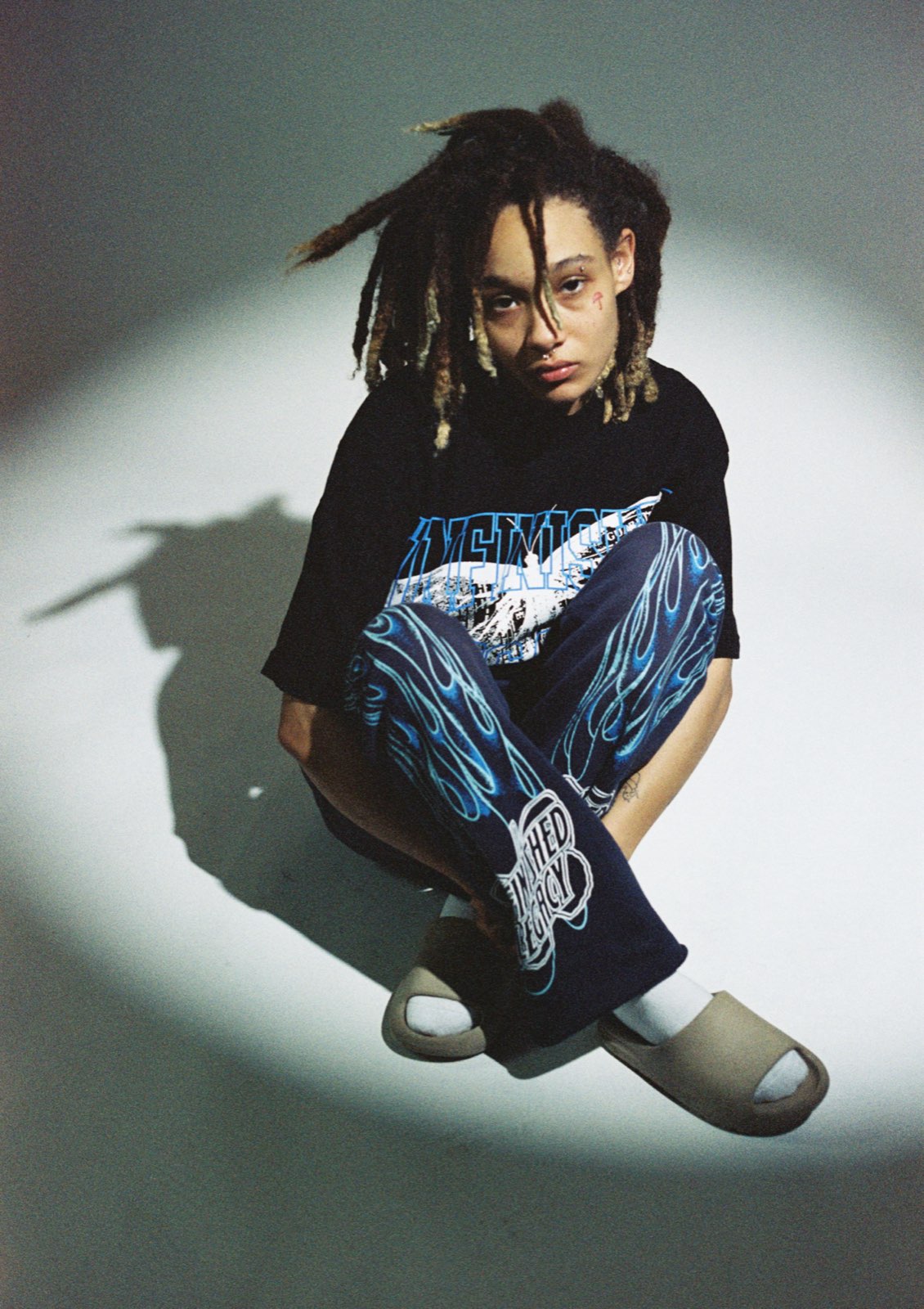 Portrait, black tee, blue flame pants, studio