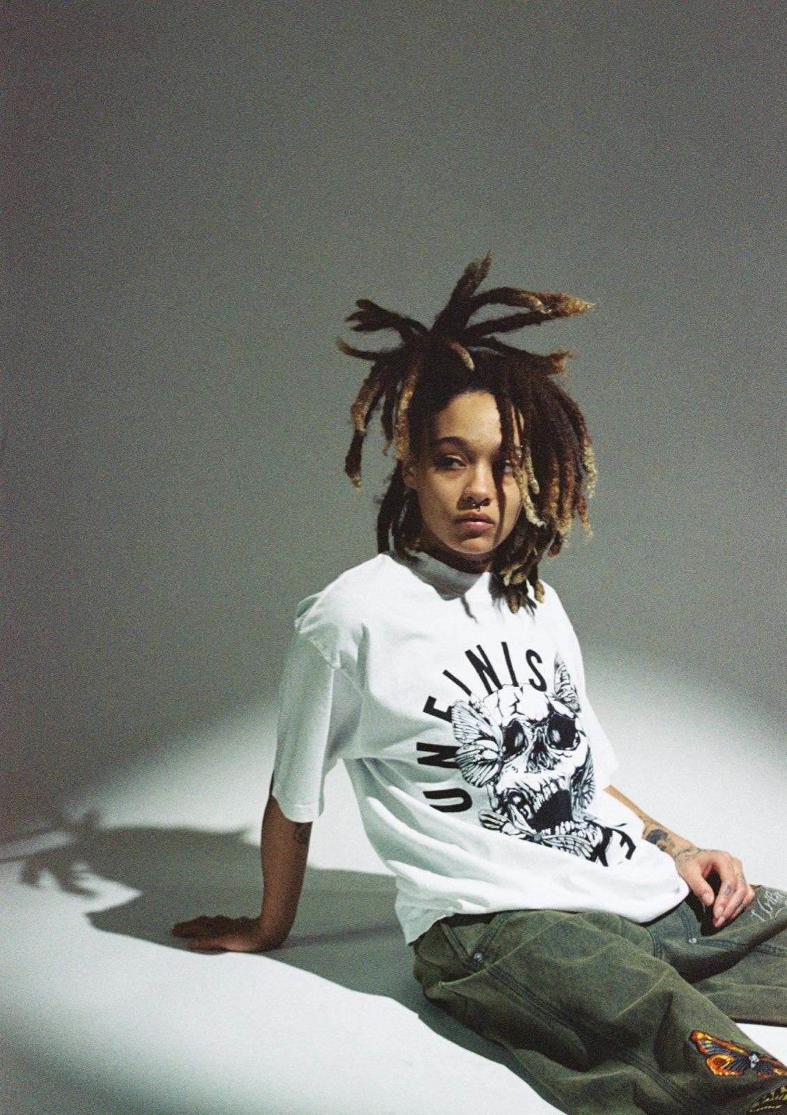 Portrait, white skull tee, dreads, studio